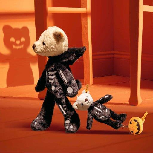 Two plush toys resembling skeletons with bat wings on an orange floor.